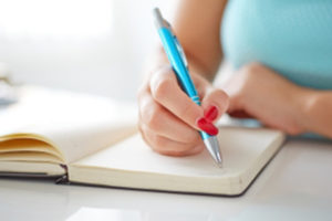 woman writing in diary