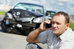 man on the phone after a car accident